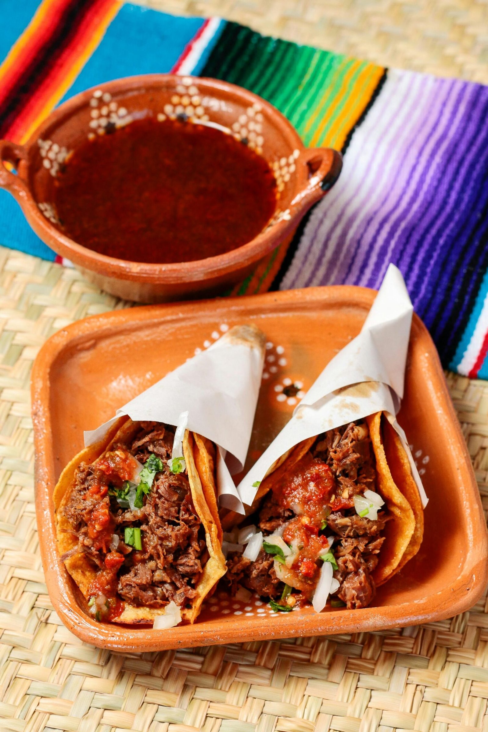 Savor the authentic Mexican tacos filled with spicy beef and vegetables, served with red sauce.