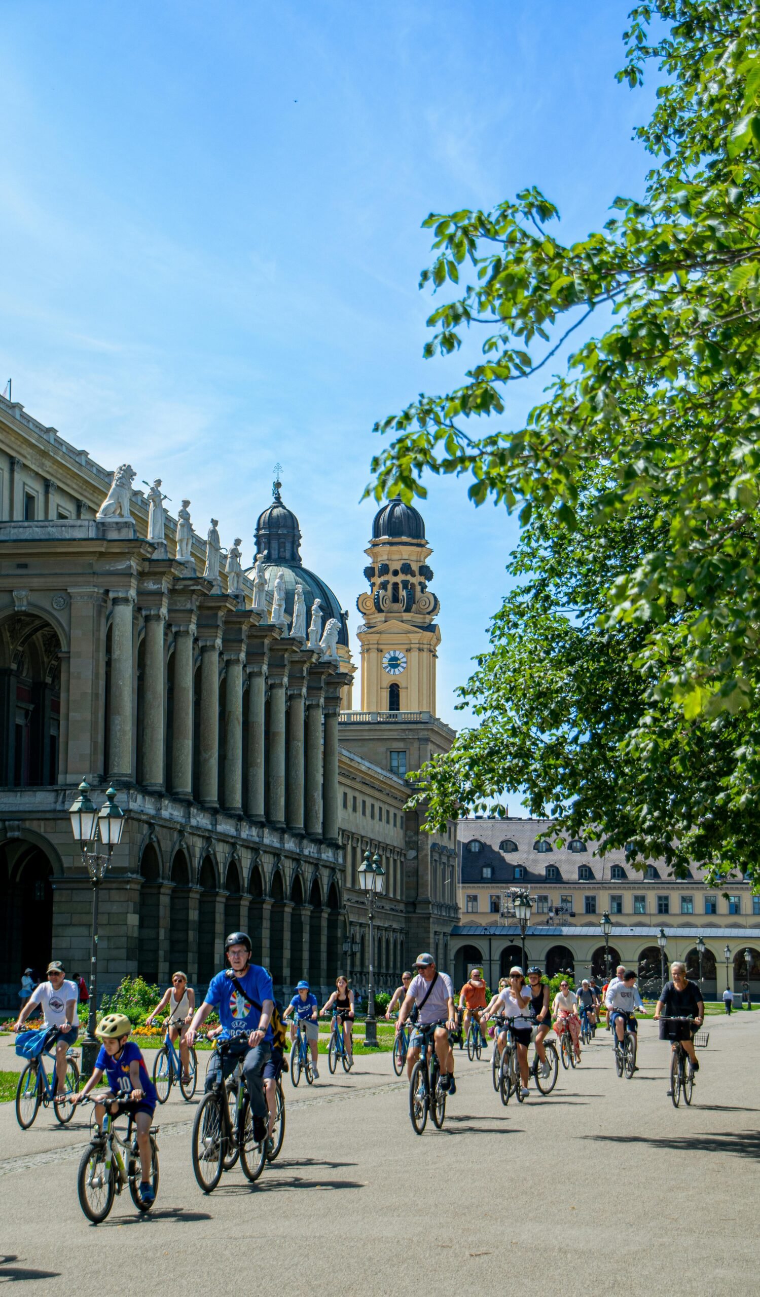 Group of people biking near architectural landmarks in Munich, Germany.