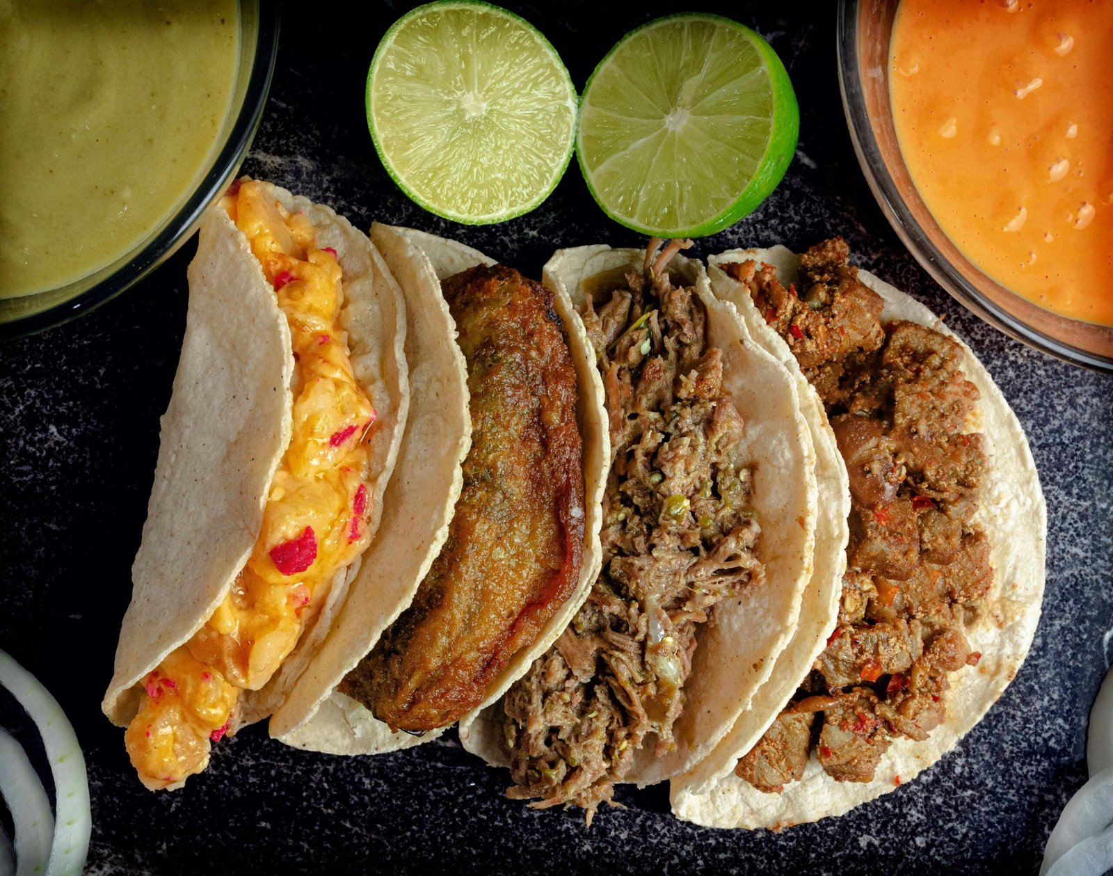 Delicious assortment of traditional Mexican tacos with lime and sauces from Monterrey, Mexico.